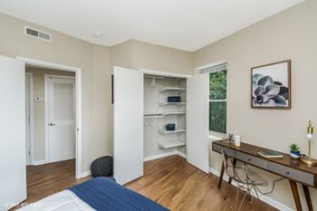 a bedroom with a bed and a desk